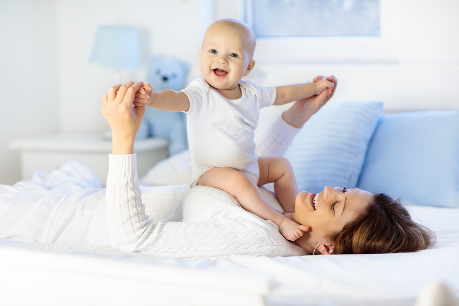 bigstock Mother And Baby On A White Bed 257985100 - Life and Health